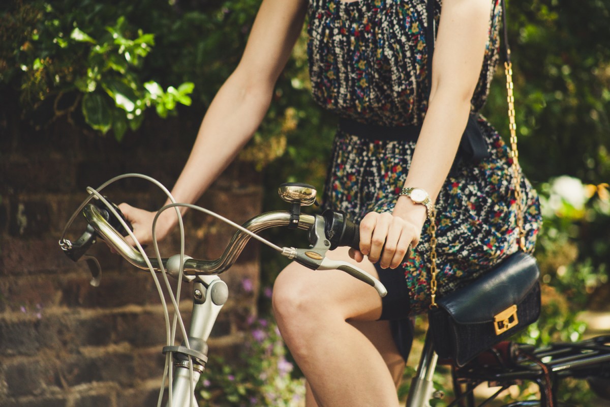 woman in sundress riding bike