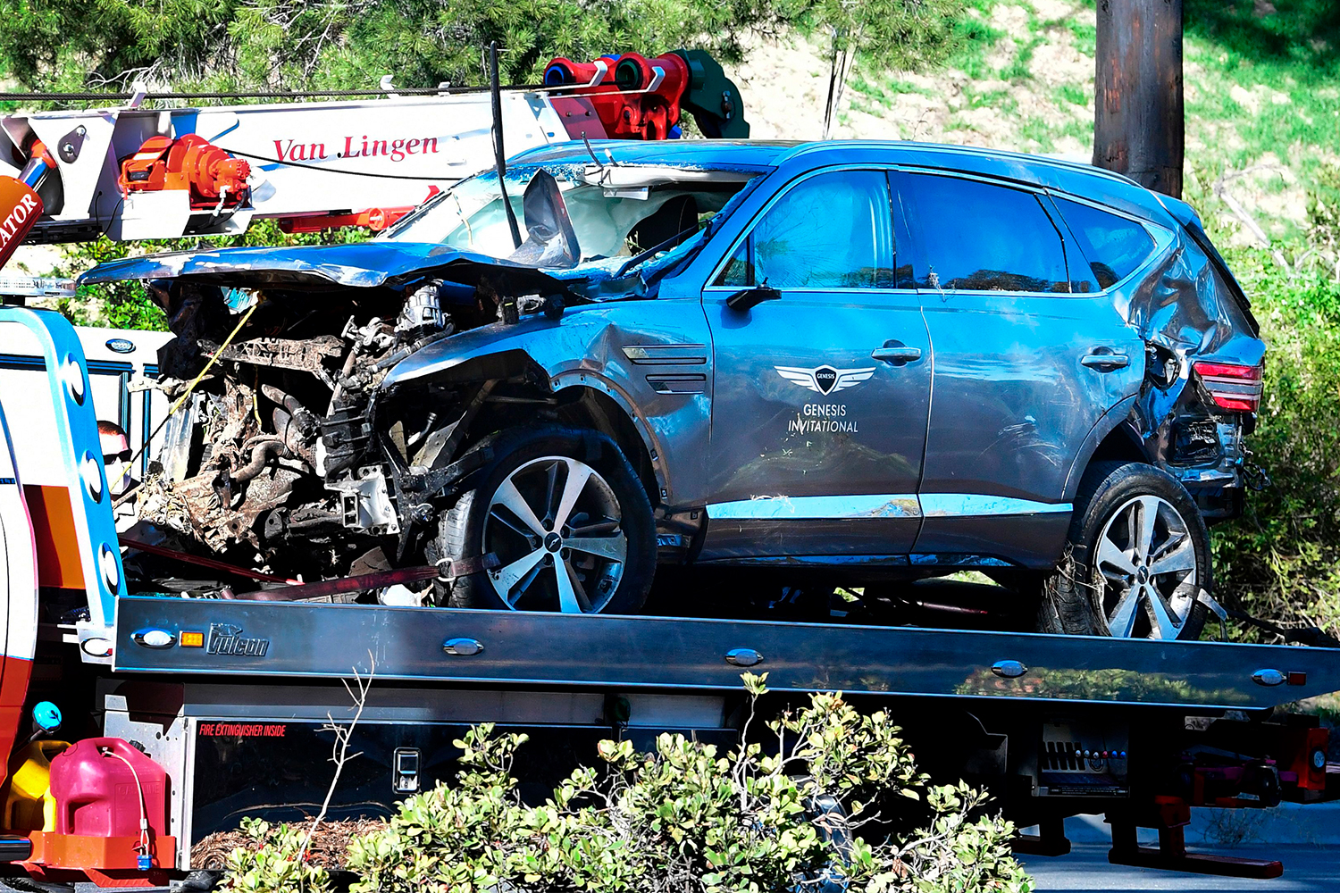 A tow truck recovers the Genesis GV80 SUV driven by golfer Tiger Woods in Rancho Palos Verdes, California, on February 23, 2021, after a rollover accident