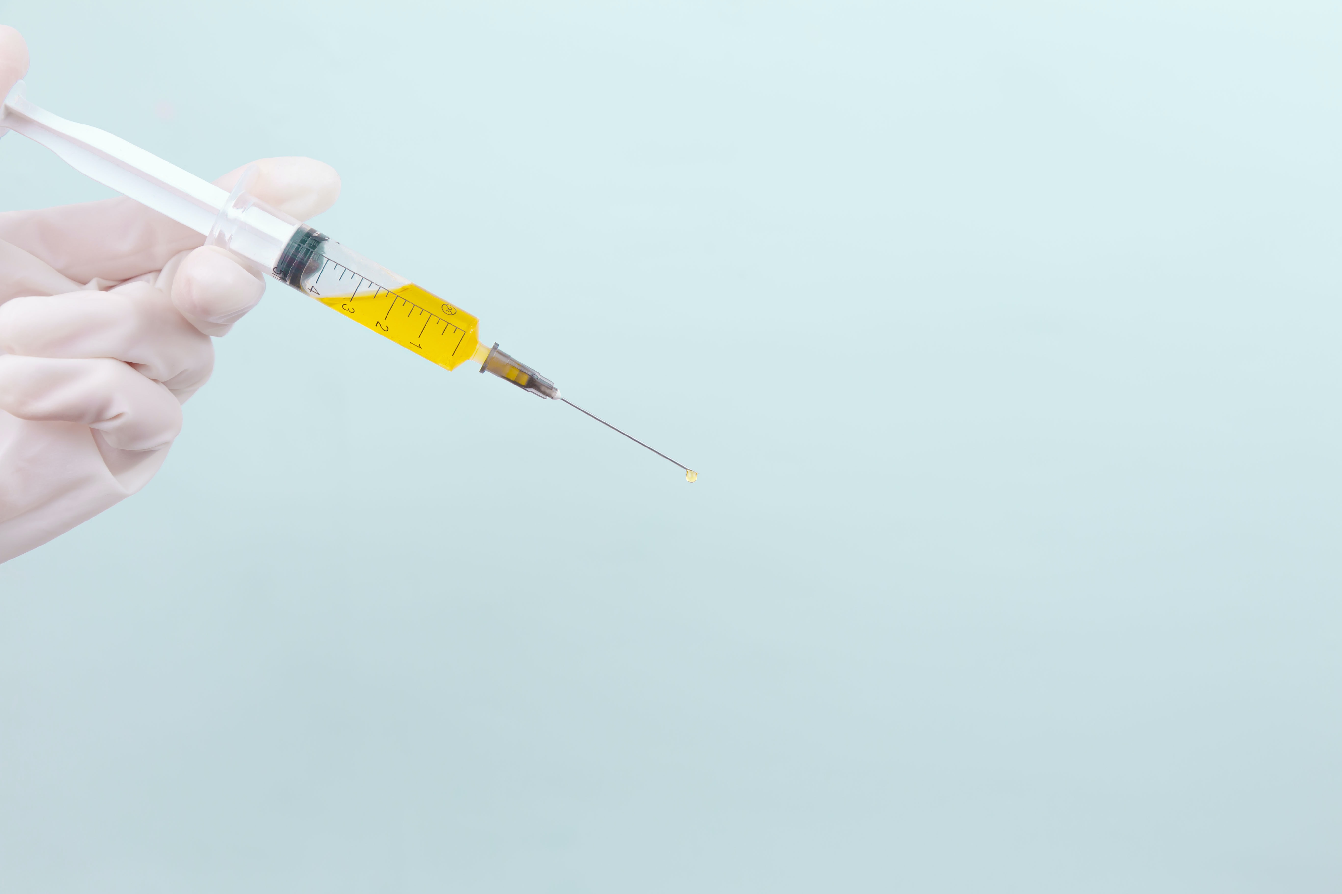 vaccine needle against blue background