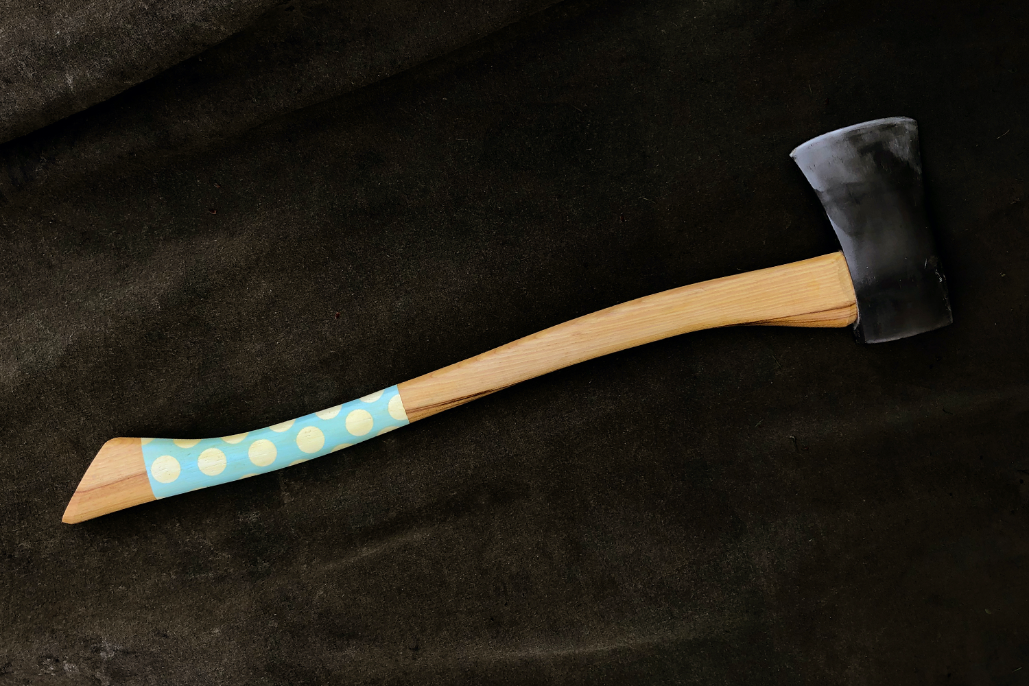 A polka dot axe from Best Made called the Handsome Dan on a black background