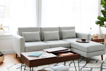 a grey Burrow modular sectional couch staged in a room with a wooden coffee table
