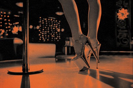 woman wearing platform heels stands near stripper pole