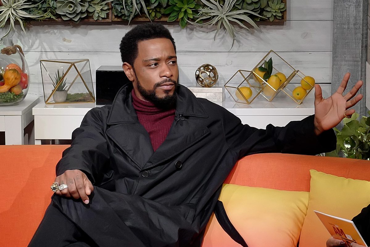Lakeith Stanfield sits on a couch at BuzzFeed's "AM To DM" show