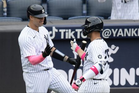 Gleyber Torres of the New York Yankees is congratulated by Gary Sanchez after hitting a solo home run against the Washington Nationals