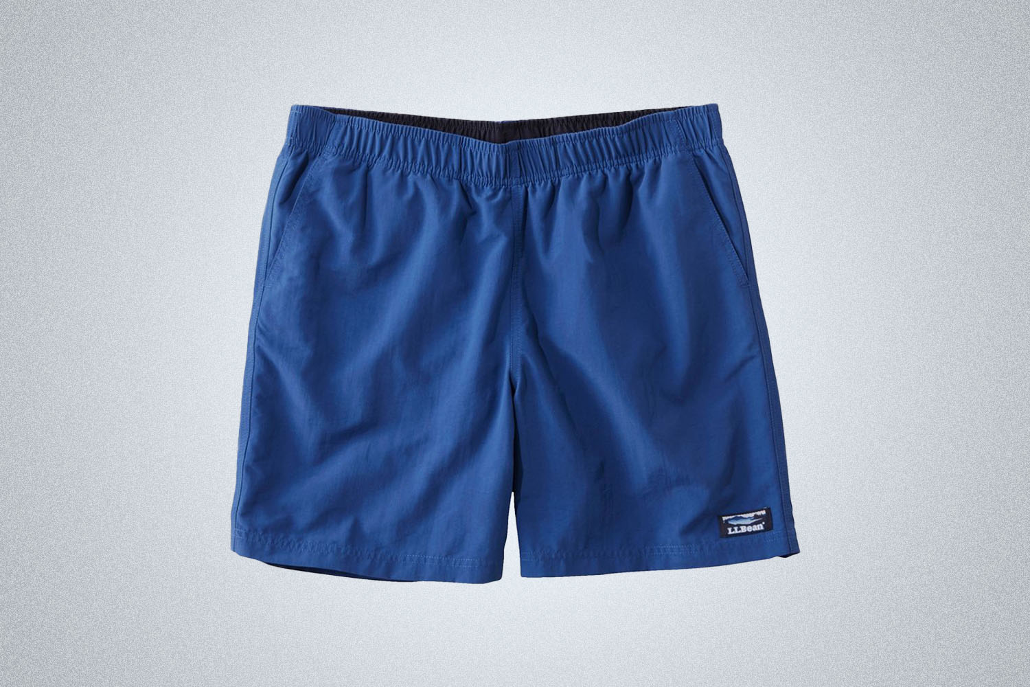 a pair of nylon shorts on a grey background 