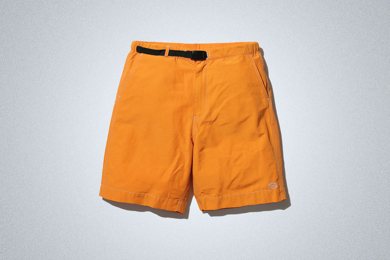 a pair of nylon shorts on a grey background