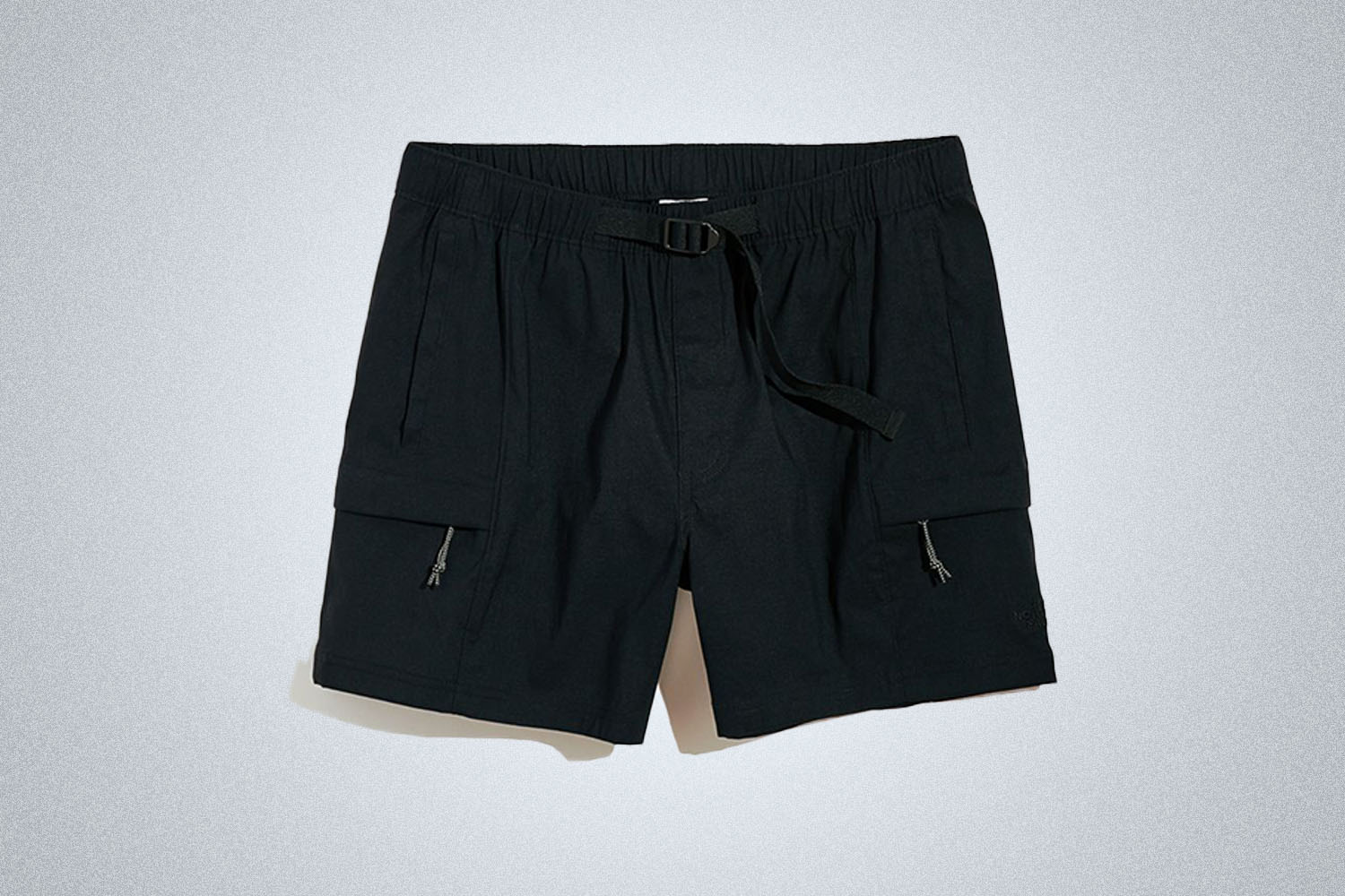 a pair of nylon shorts on a grey background