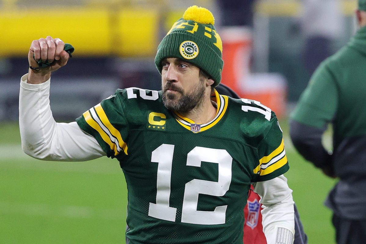 Aaron Rodgers of the Green Bay Packers in his uniform and a beanie