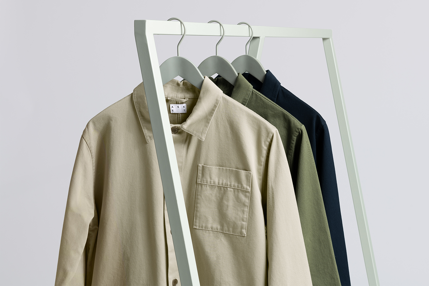 A clothing rack holding overshirts from menswear brand Asket