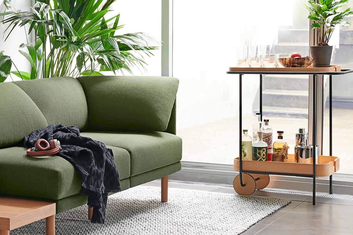 Dram Bar Cart from Burrow next to a Burrow sofa in a living room