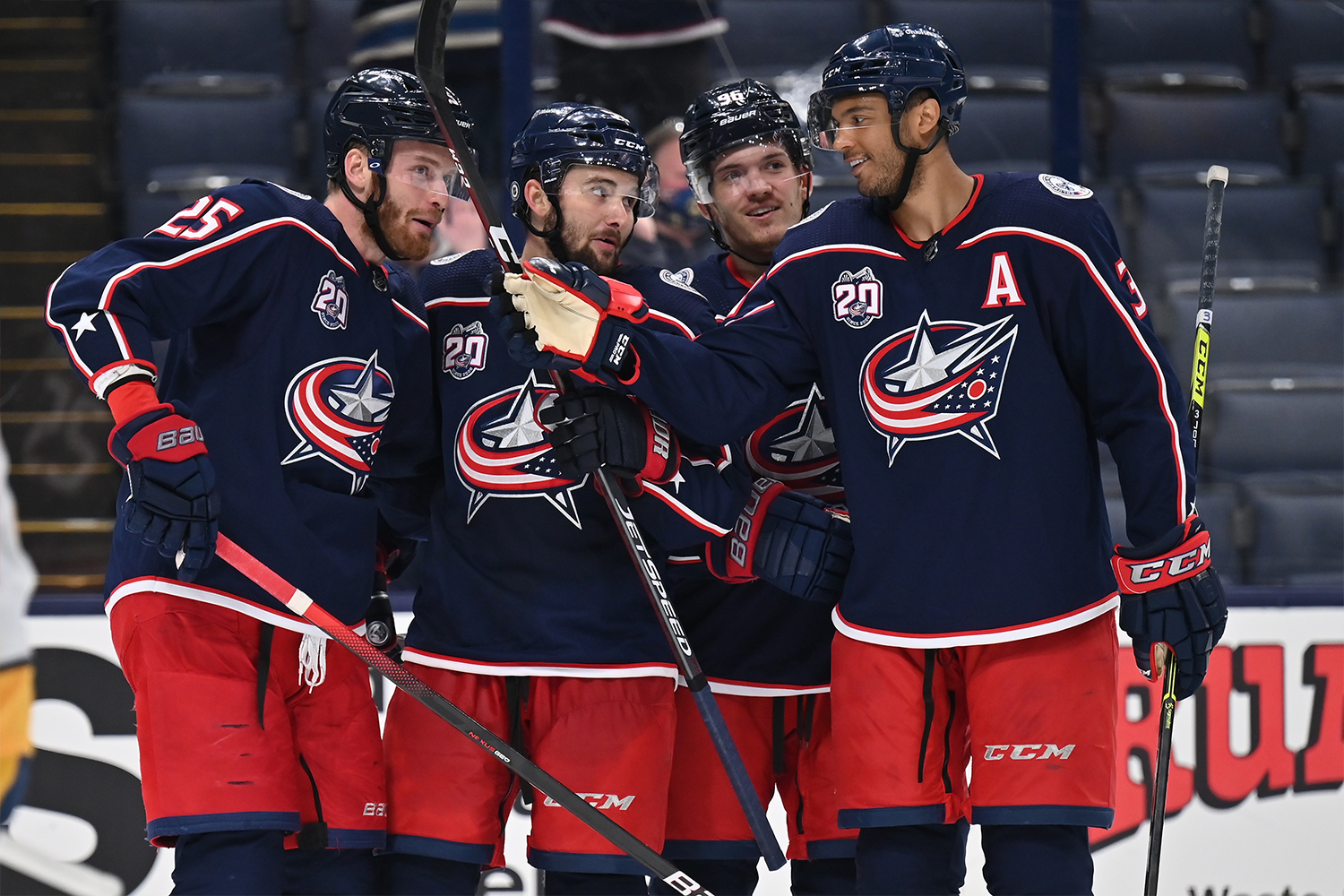 Mikhail Grigorenko #25, far left, Emil Bemstrom #52, Jack Roslovic #96 and Seth Jones #3, all of the Columbus Blue Jackets celebrate Bemstrom's second goal of the third period against the Nashville Predators at Nationwide Arena on May 3, 2021 