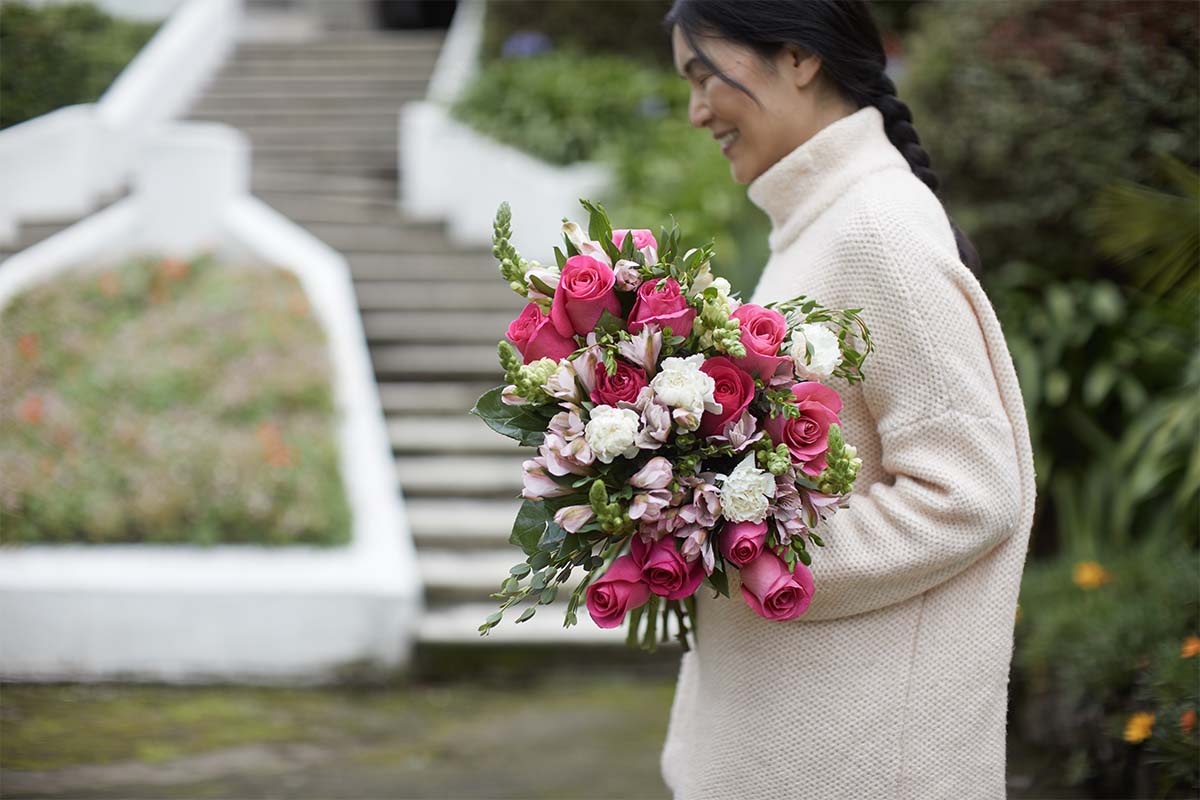 A mom holding a bouquet from The Bouqs Co