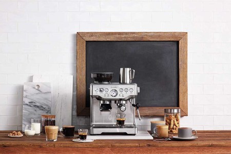 The Breville BES870BSXL The Barista Express Coffee Machine on a counter; Amazon has this model on sale for $100 off