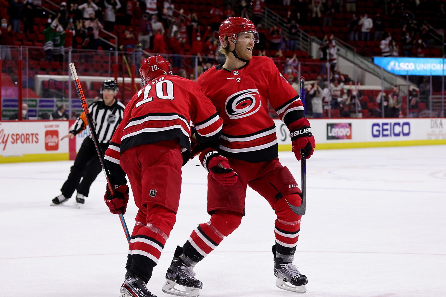 Dougie Hamilton #19 of the Carolina Hurricanes scores a goal in overtime and celebrates with teammate Sebastian Aho #20 during an NHL game against the Columbus Blue Jackets on May 1, 2021