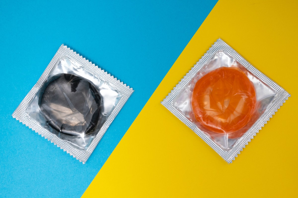 Two condoms on blue and yellow background