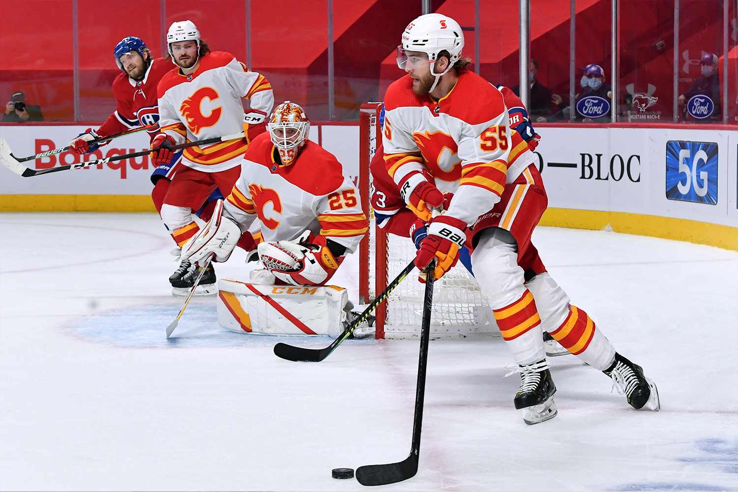 Noah Hanifin #55 of the Calgary Flames looks to pass the puck against against the Montreal Canadiens in the NHL game at the Bell Centre on April 16, 2021