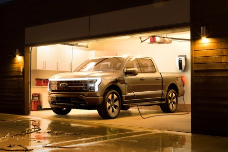 Ford F-150 Lightning electric pickup truck charging in a garage