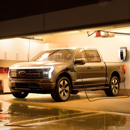 Ford F-150 Lightning electric pickup truck charging in a garage