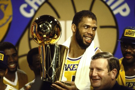 Kareem Abdul-Jabbar holds the Walter A. Brown championship trophy