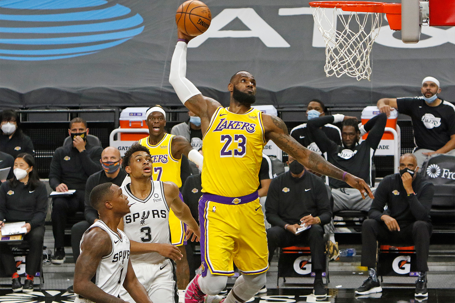 LeBron James #23 of the Los Angeles Lakers dunks past spurs defenders 