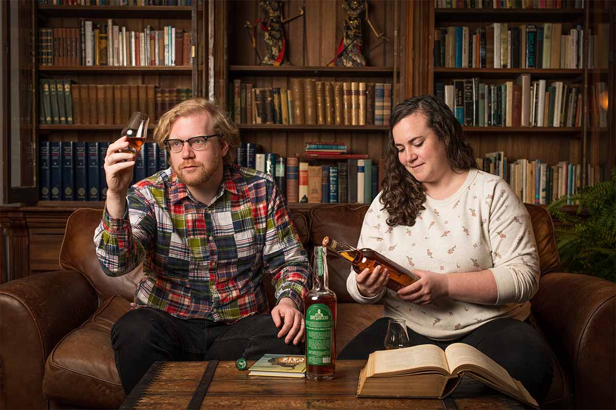 Lost Lantern founders Adam Polonski and Nora Ganley-Roper at home drinking whiskey