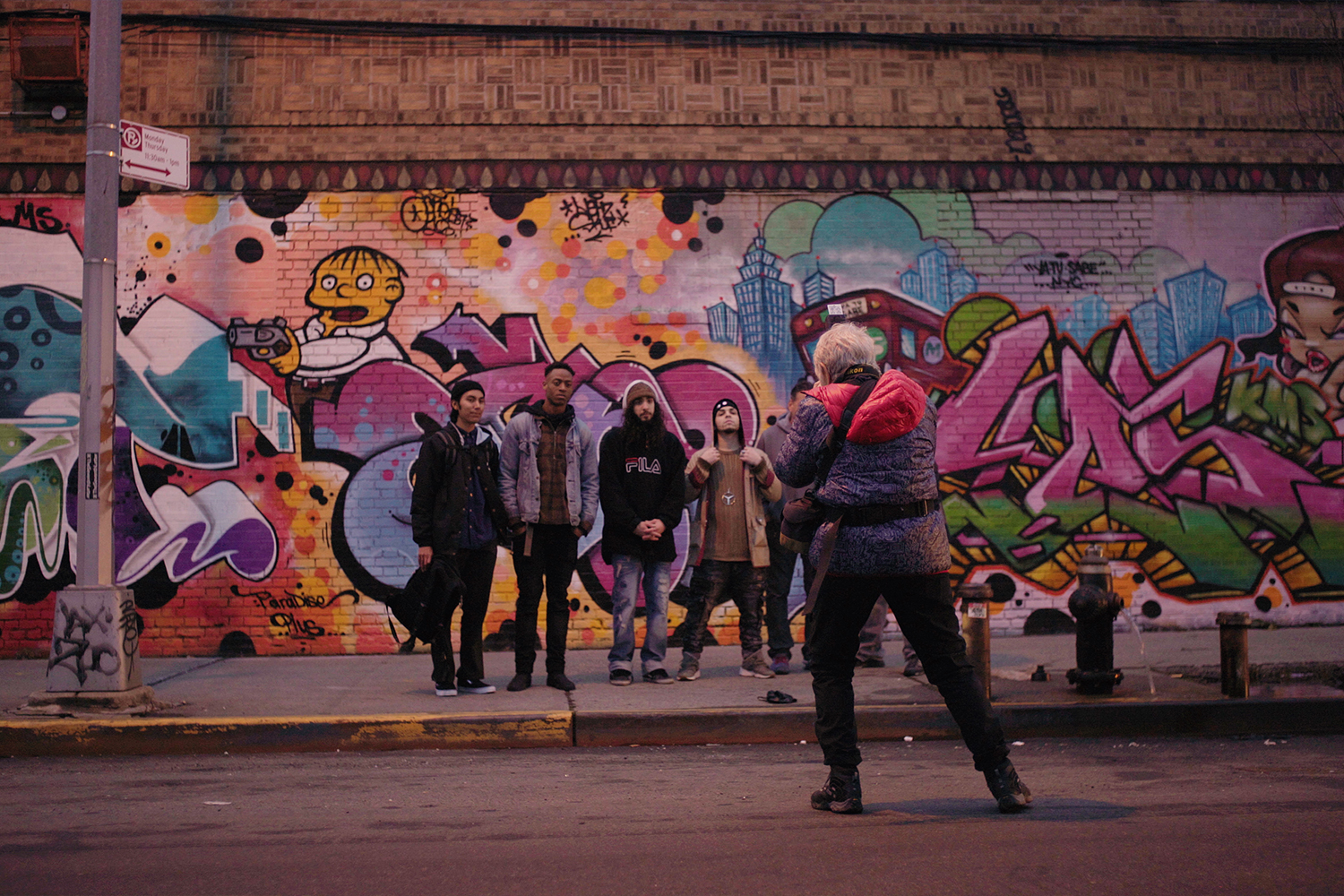 Martha Cooper shooting in front of a mural