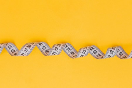 measuring tape on yellow background