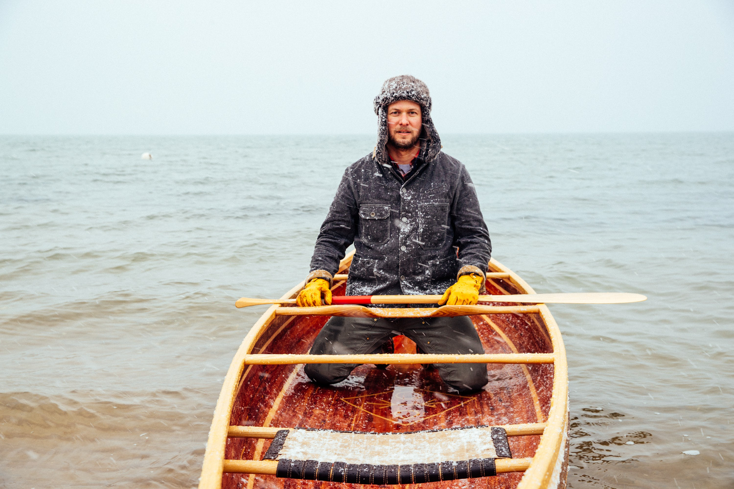 Wooden boatbuilder Trent Preszler paddles a canoe he made in the cold winter waters of Great Peconic Bay in Mattituck on Tuesday, Jan. 31, 2017. The canoe is made of aromatic red cedar, black walnut and Basswood, with custom cast bronze cutwater made by Greenport based metalsmith Kristian Iglesias, KAI Design.