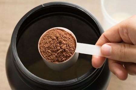 A scoop of brown pre-workout powder