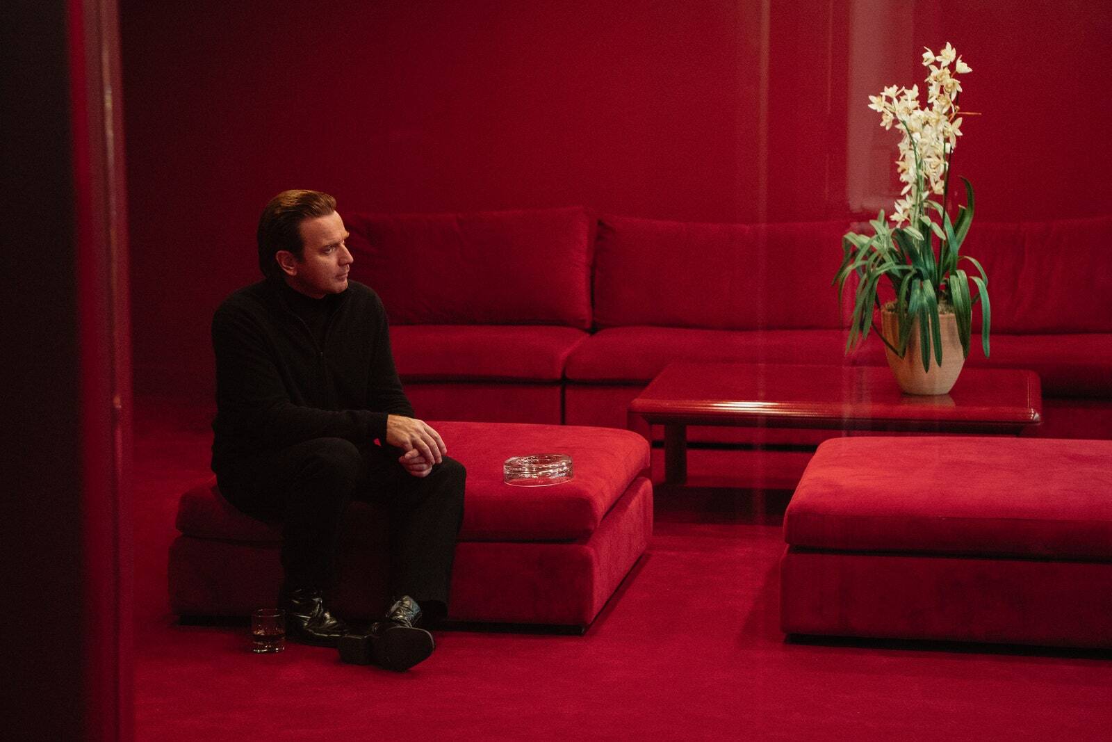 Halston (portrayed by Ewan MacGregor) admires one of his precious orchids in the new Netflix series on his life and career