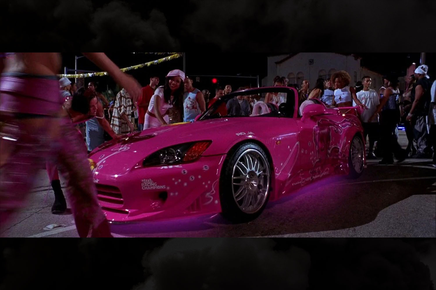 Suki's pink 2000 Honda S2000 from 2 Fast 2 Furious with underglow lighting is one of our favorite from the Fast and Furious franchise