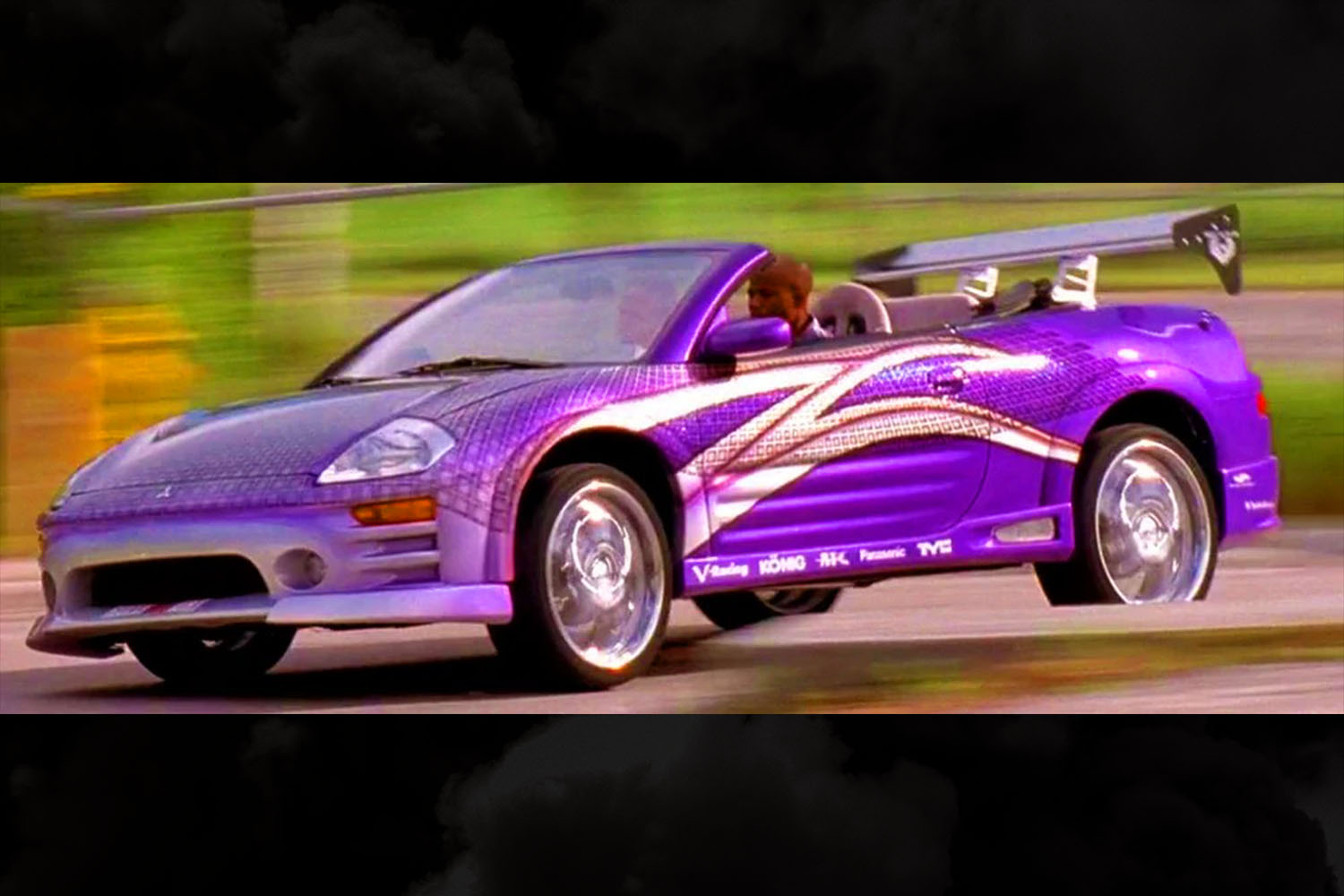 Roman Pearce (Tyrese Gibson) driving an electric purple 2003 Mitsubishi Eclipse Spyder GTS in 2 Fast 2 Furious