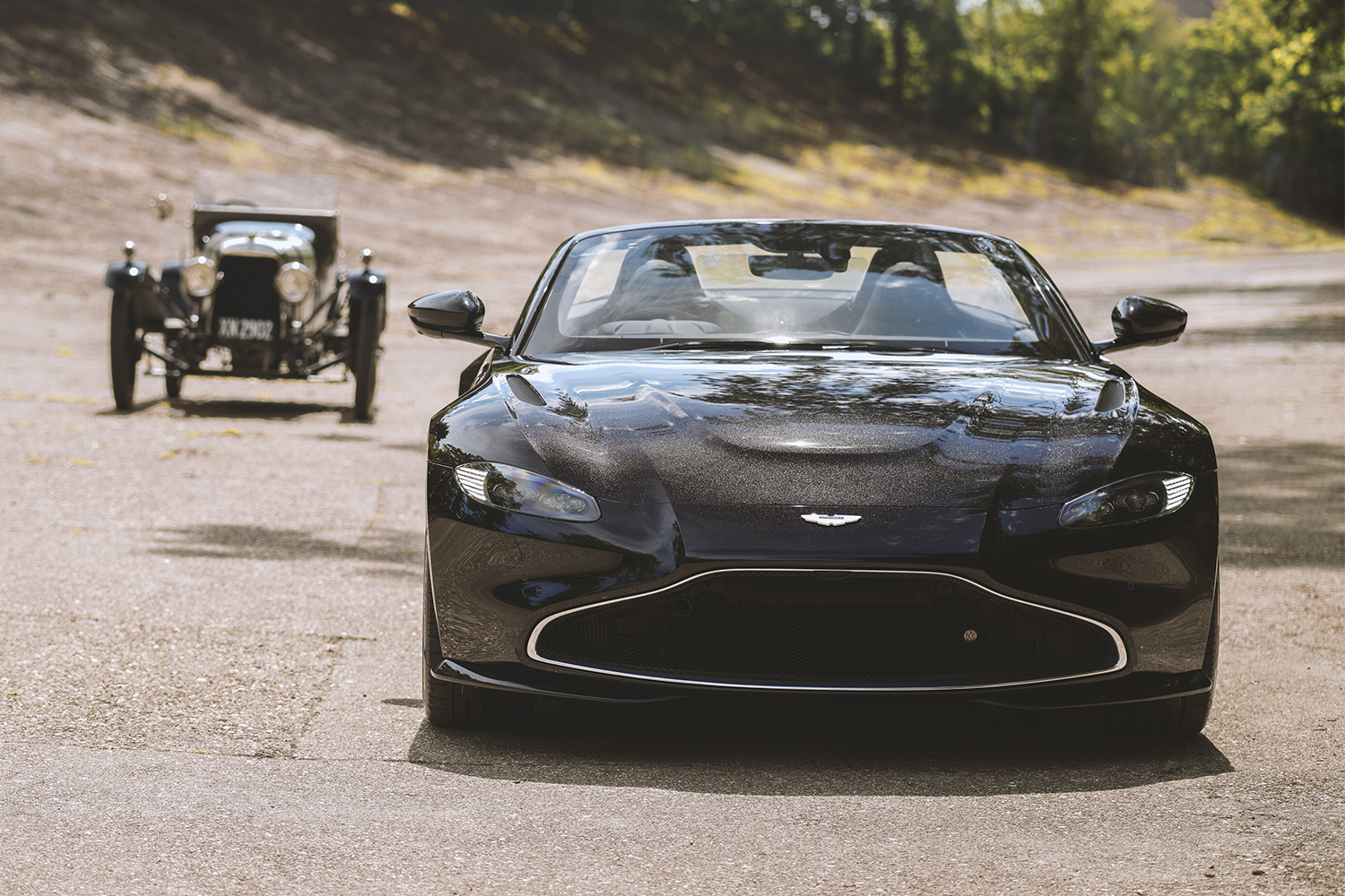 A new Aston Martin Vantage Roadster flanked by the A3, the British marque's oldest surviving car. The Vantage is an anniversary tribute to the 1921 car.