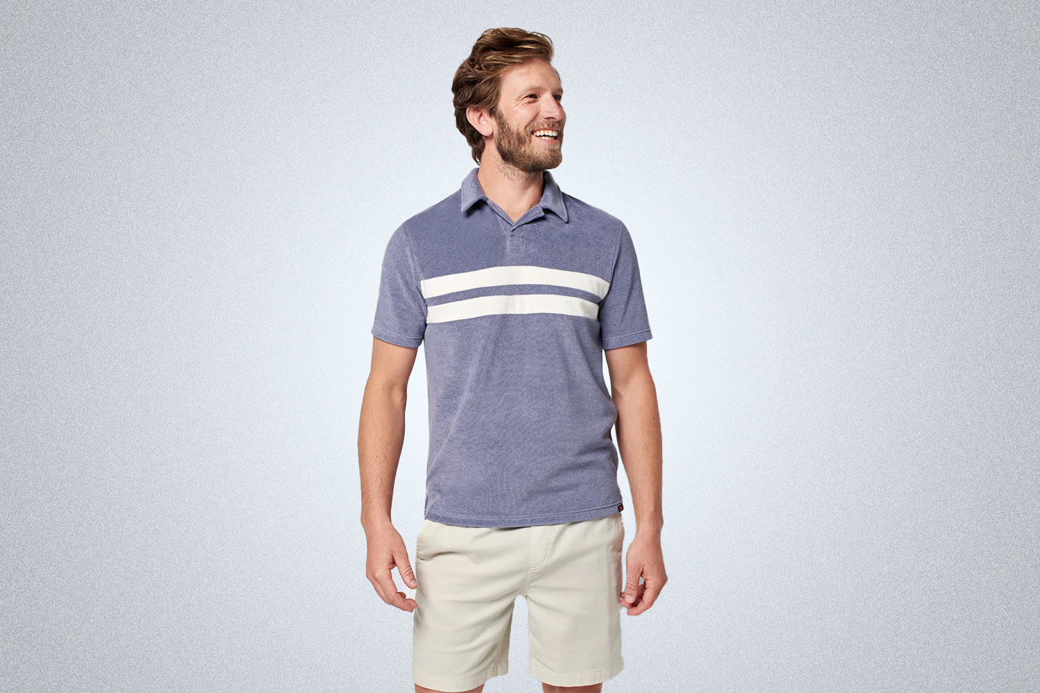A purple striped terry polo from Faherty on a grey background