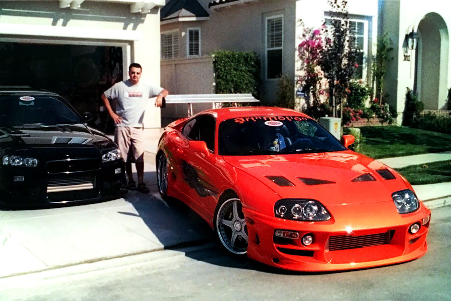 Craig Lieberman, technical advisor on the first two Fast and Furious movies, standing next to his orange Toyota Supra