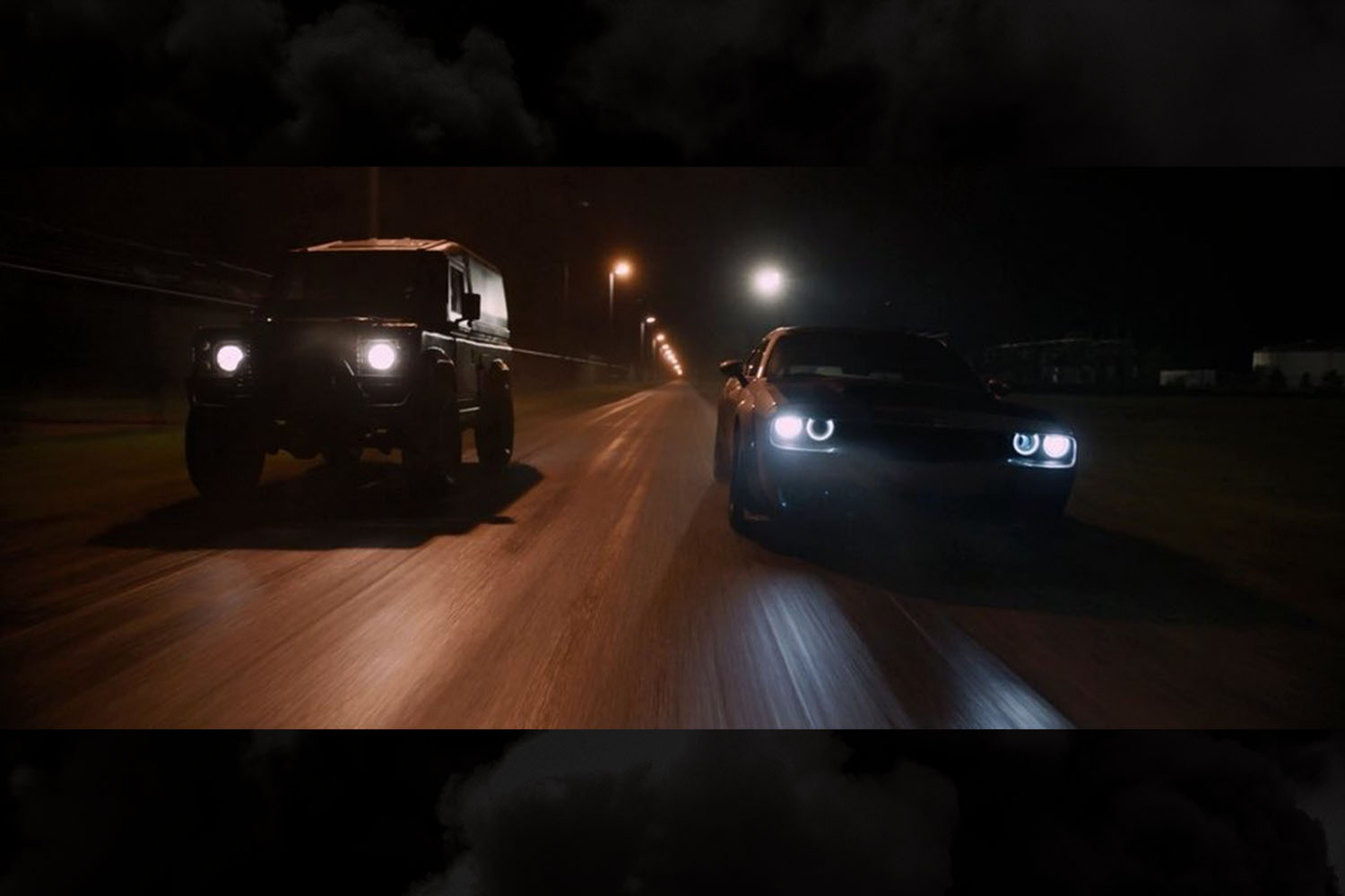 Luke Hobbs played by Dwayne "The Rock" Johnson driving a Land Rover Defender at night in a scene from The Fate of the Furious