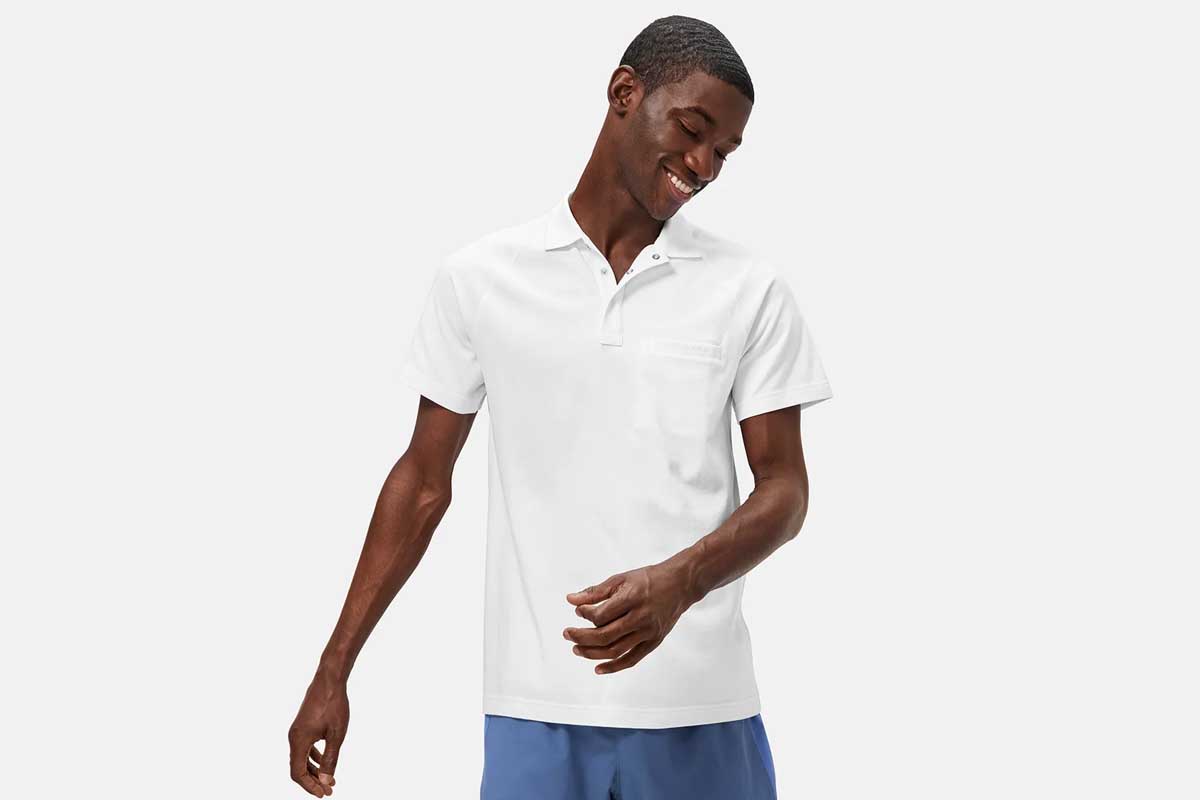 A man wearing a white Sport Polo from Outdoor Voices