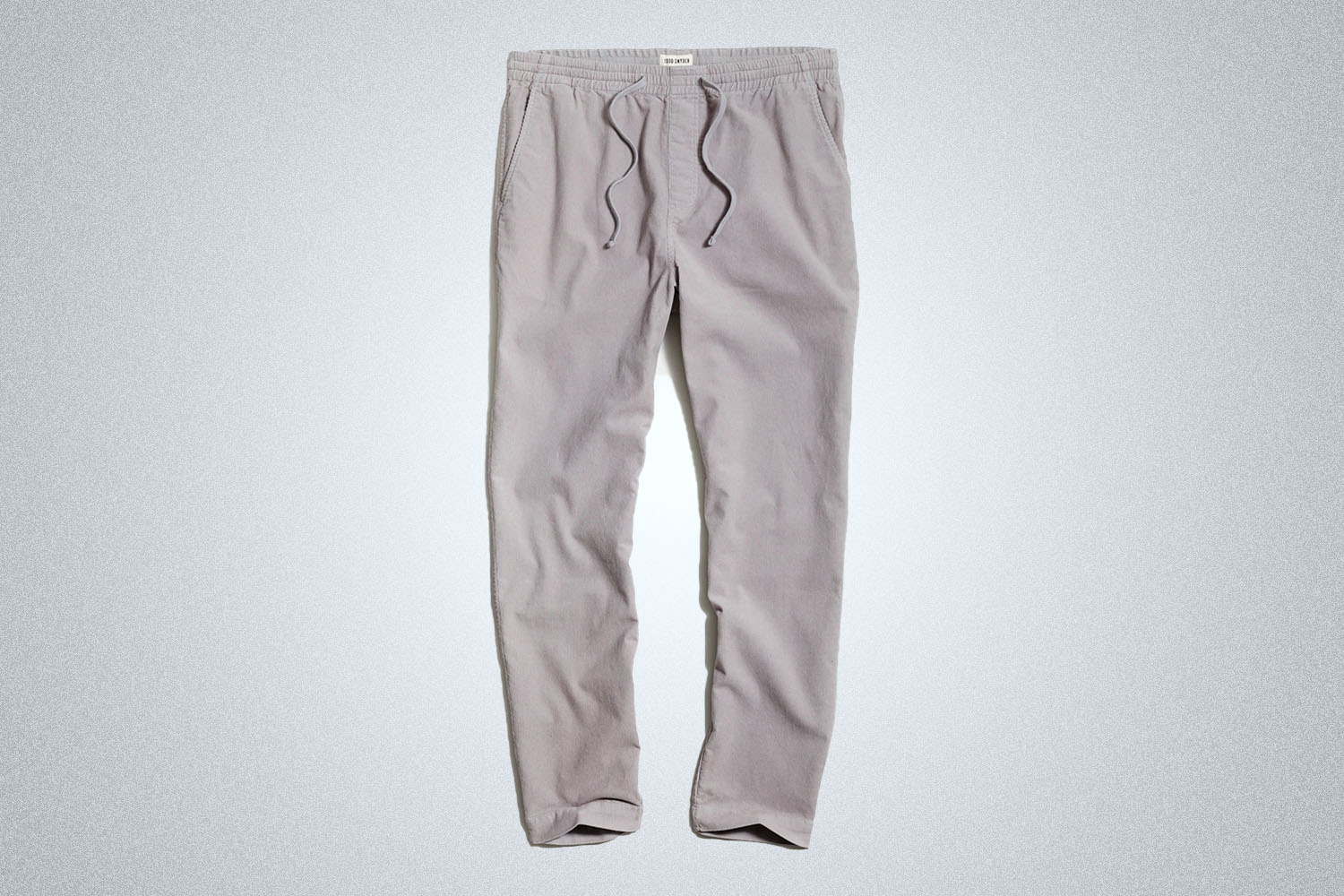 a pair of grey drawstring pants from Todd Snyder on a grey background