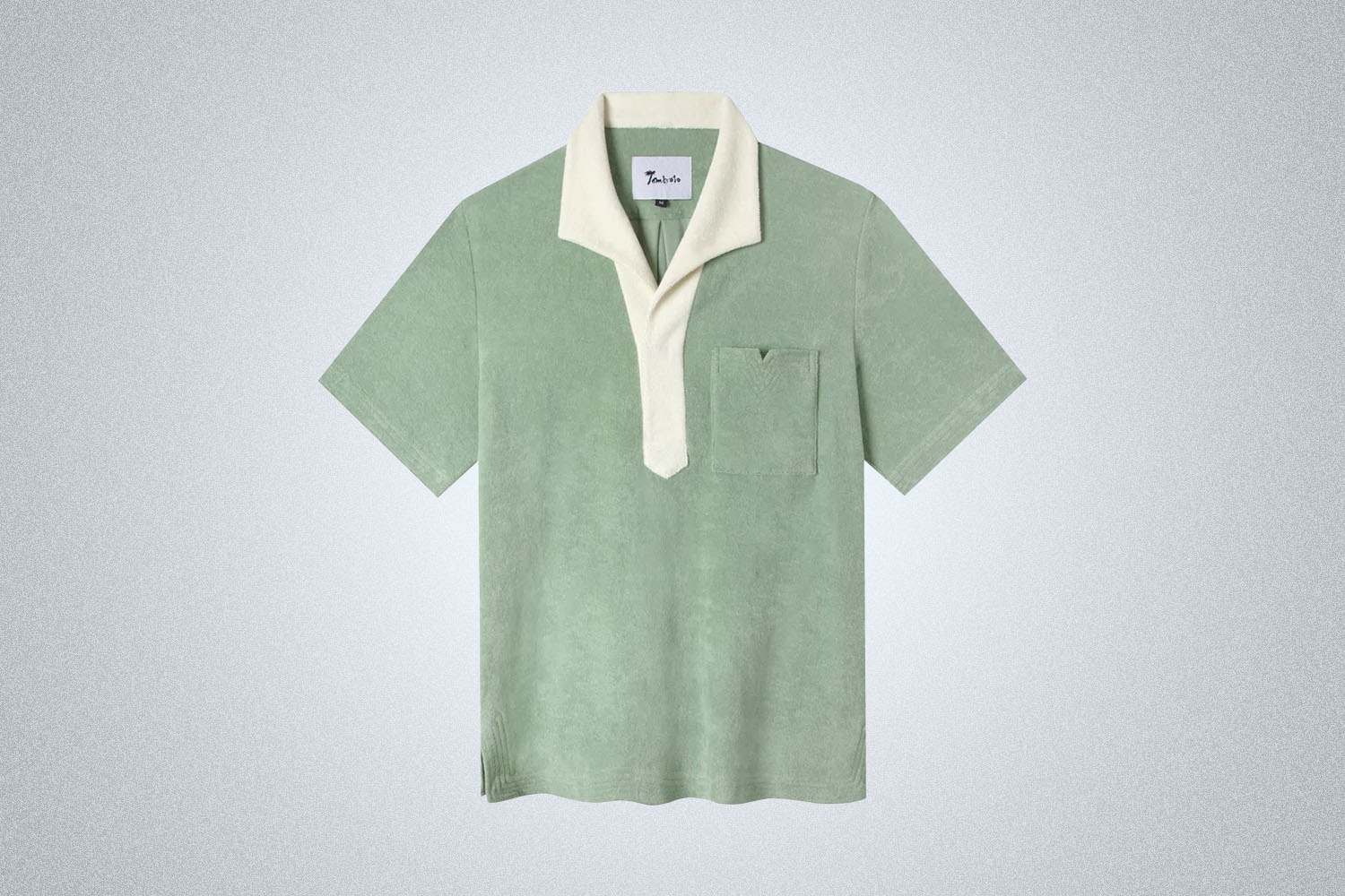 a green terry polo from Tombolo on a grey background