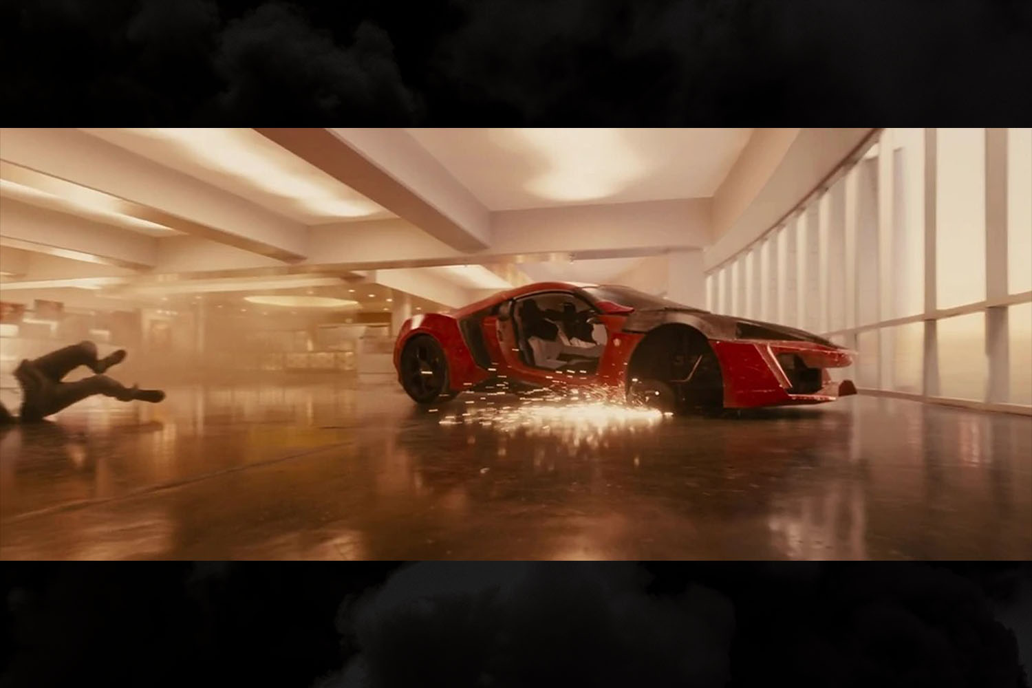 The red W Motors Lykan HyperSport getting wrecked as Dom and Brian jump it through skyscrapers in the movie "Furious 7"