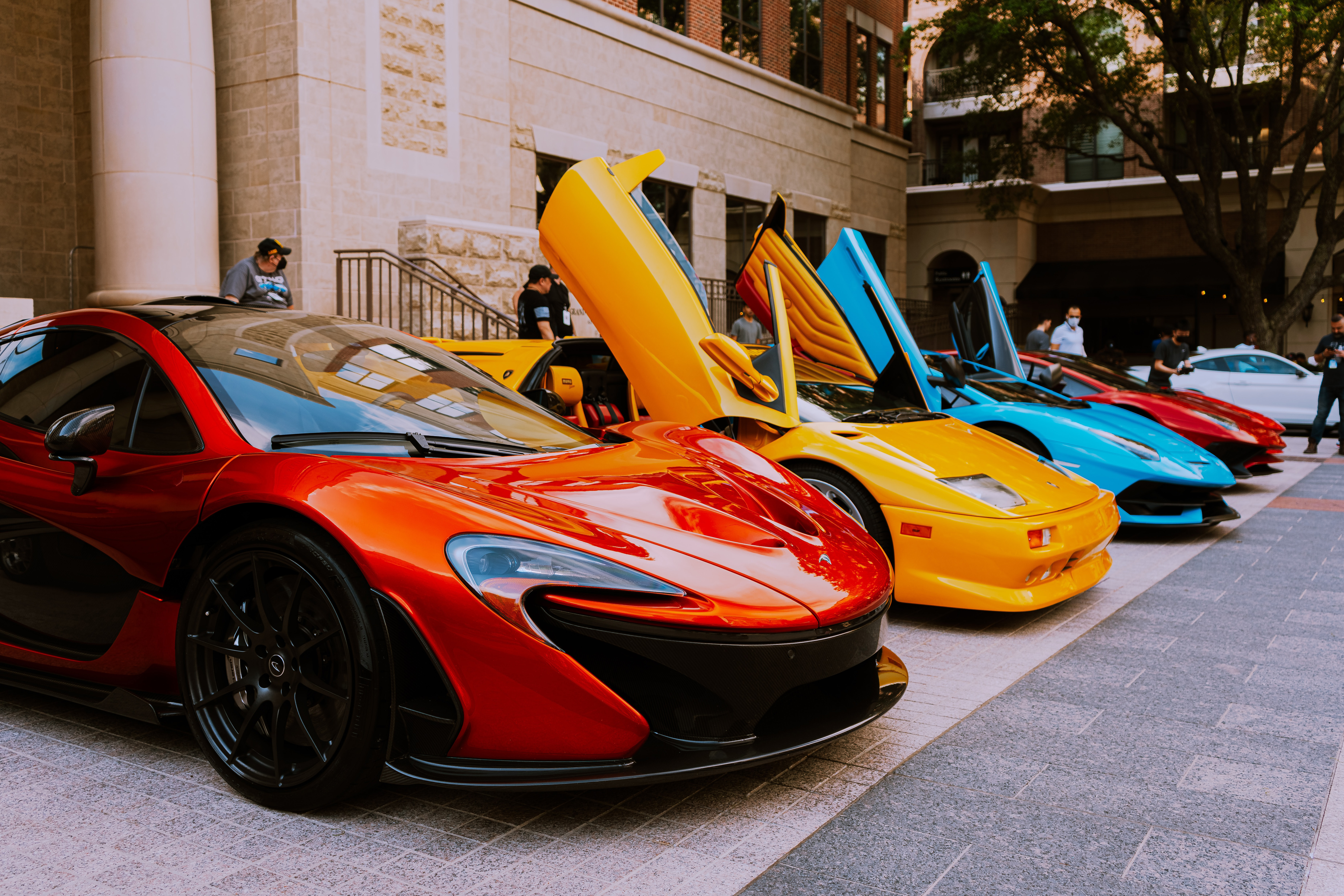 fast cars lined up outside a hotel