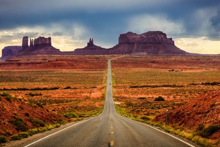 Highway 163 through Monument Valley is one of the most scenic drives and road trips in America, as evidenced by this view of the towering sandstone buttes in the Navajo Valley Park in Arizona.