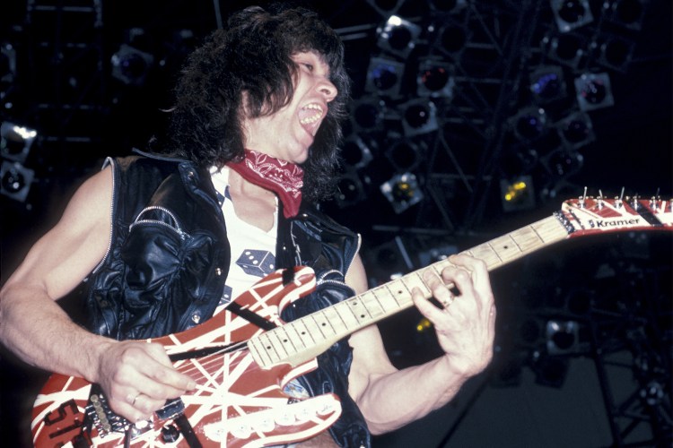 Eddie Van Halen on tour in 1984 playing a red and white Kramer Stryper guitar. One of these instruments is headed to auction at Guernsey's in July.