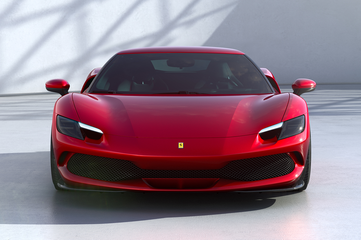 The front end of the red Ferrari 296 GTB, a new plug-in hybrid car from the Italian marque.