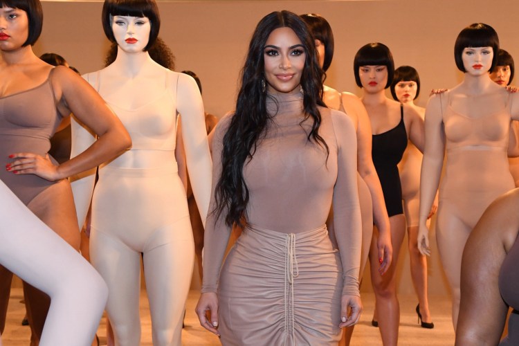 Kim Kardashian celebrates the launch of SKIMS at Nordstrom NYC. The star poses in a nude dress alongside mannequins outfitted in the brand's shapewear.
