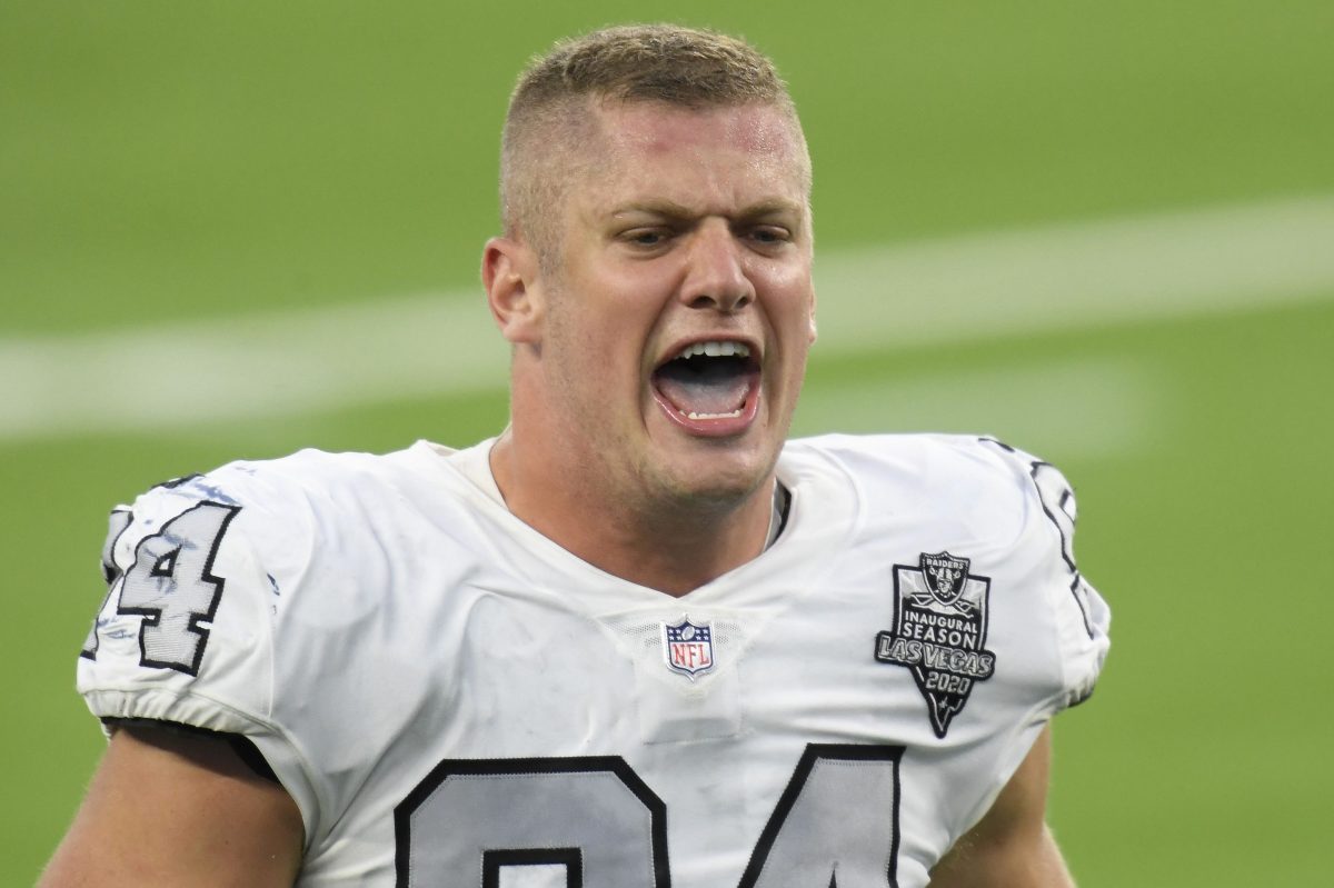 Carl Nassib of the Las Vegas Raiders celebrates on the football field. The NFL player recently came out as gay.