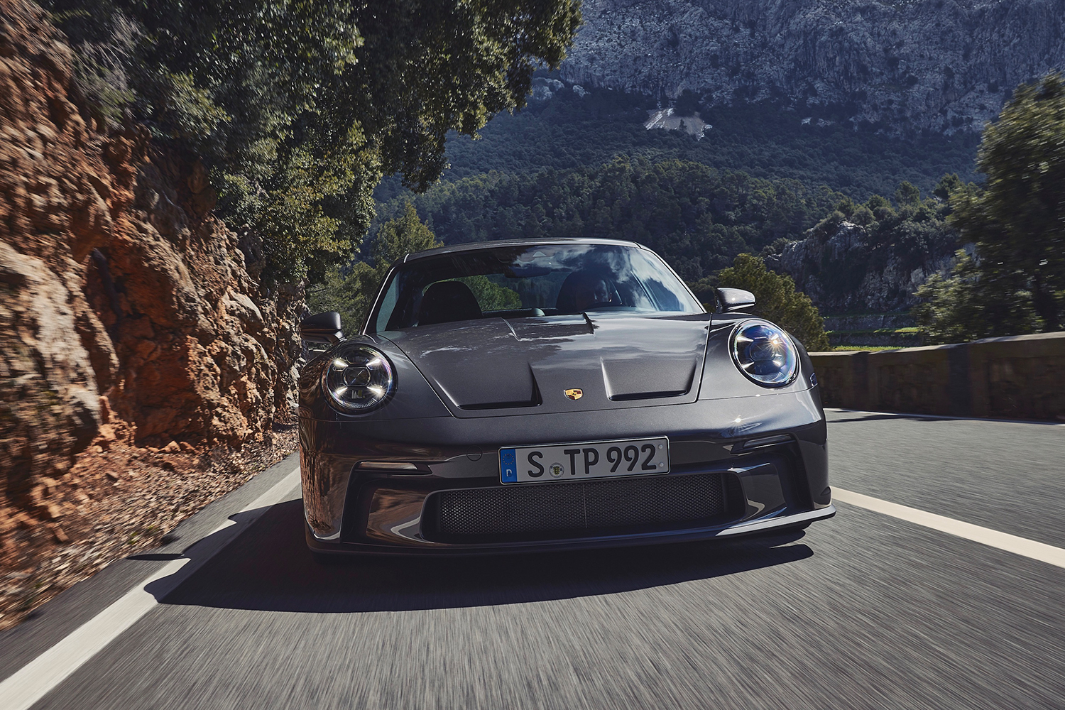 The new Porsche 911 GT3 with Touring package driving a scenic road