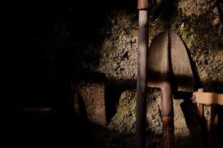 Shovels and other digging tools in the dirt