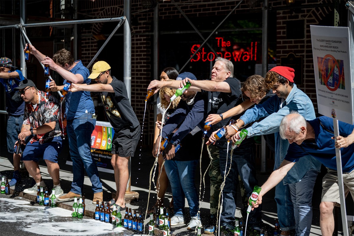 Protesters spill beer on the road as the Stonewall Inn protests Anheuser-Busch political donations to anti-trans bills lawmakers at Stonewall Inn on June 23, 2021 in New York City