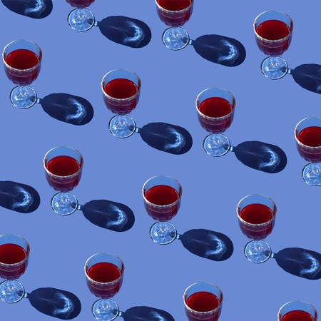 Red wine glasses on a purple background